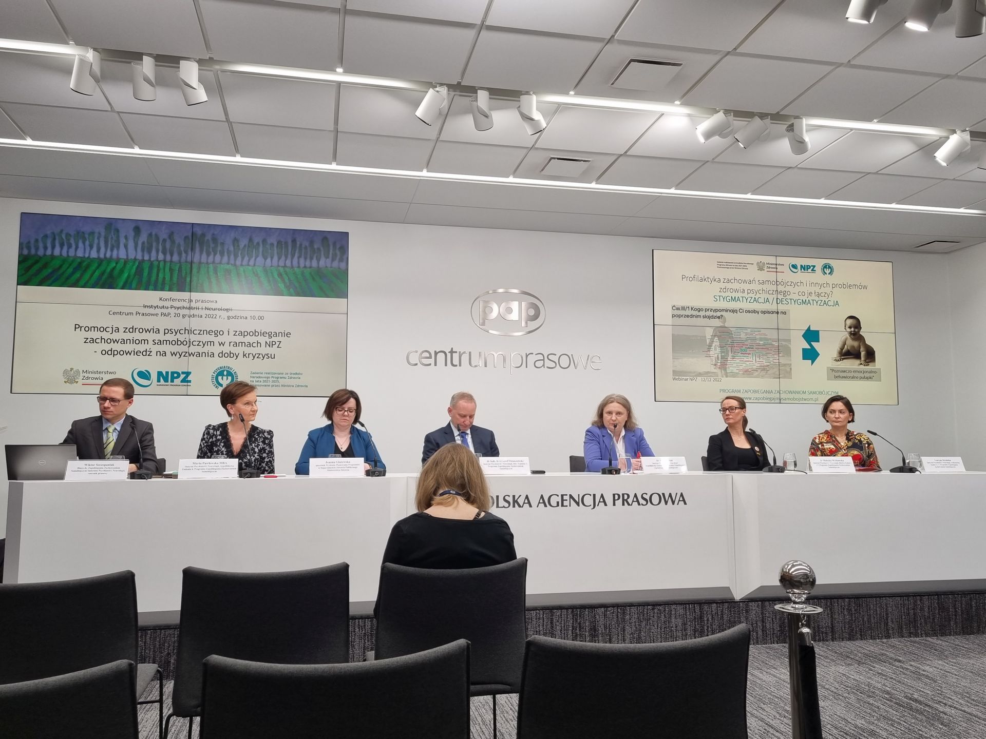 prelegenci spotkania siedzą za stołem w centrum konferencyjnym PAP, za nimi ekrany z widoczną prezentacją