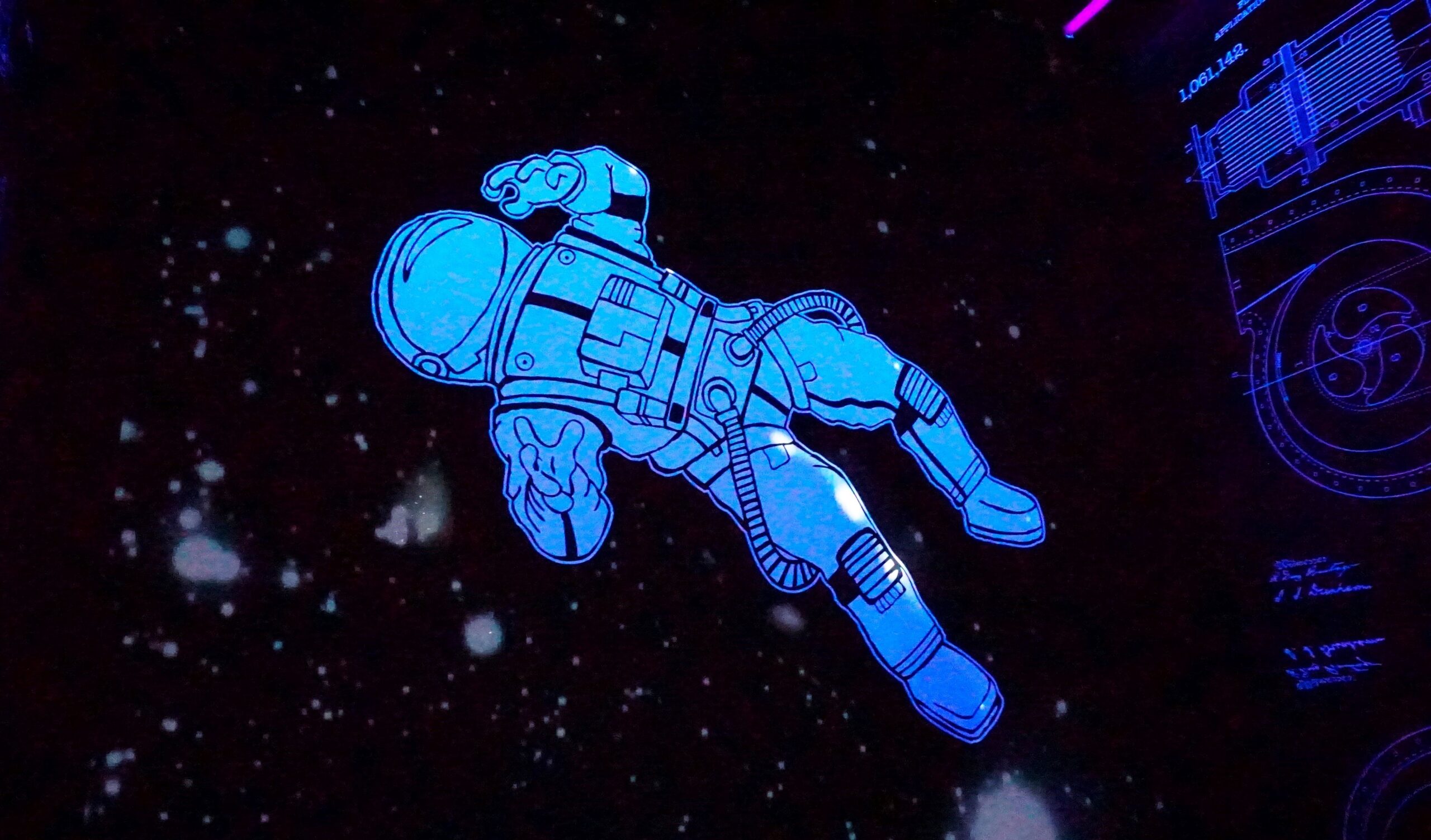 Grafika: kosmonauta w przestrzeni kosmicznej.