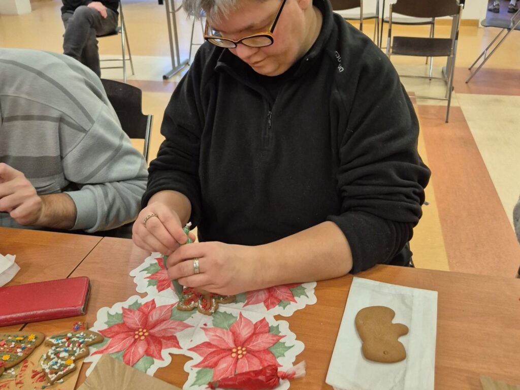 Uczestniczka projektu zdobi pierniki.