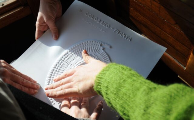 Na zdjęciu palce przesuwają się po tyflografice.