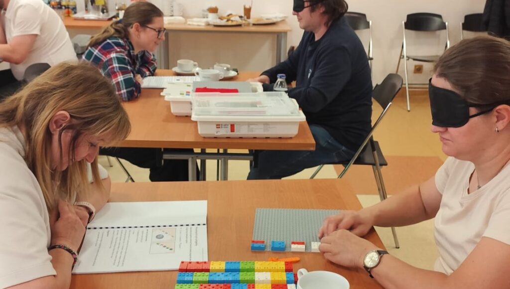 Uczestnicy warsztatów uczą się metodyki LEGO BRAILLE BRICKS.